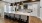 a clubroom kitchen with a bar and chairs