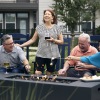 a group of people laughing around a fire